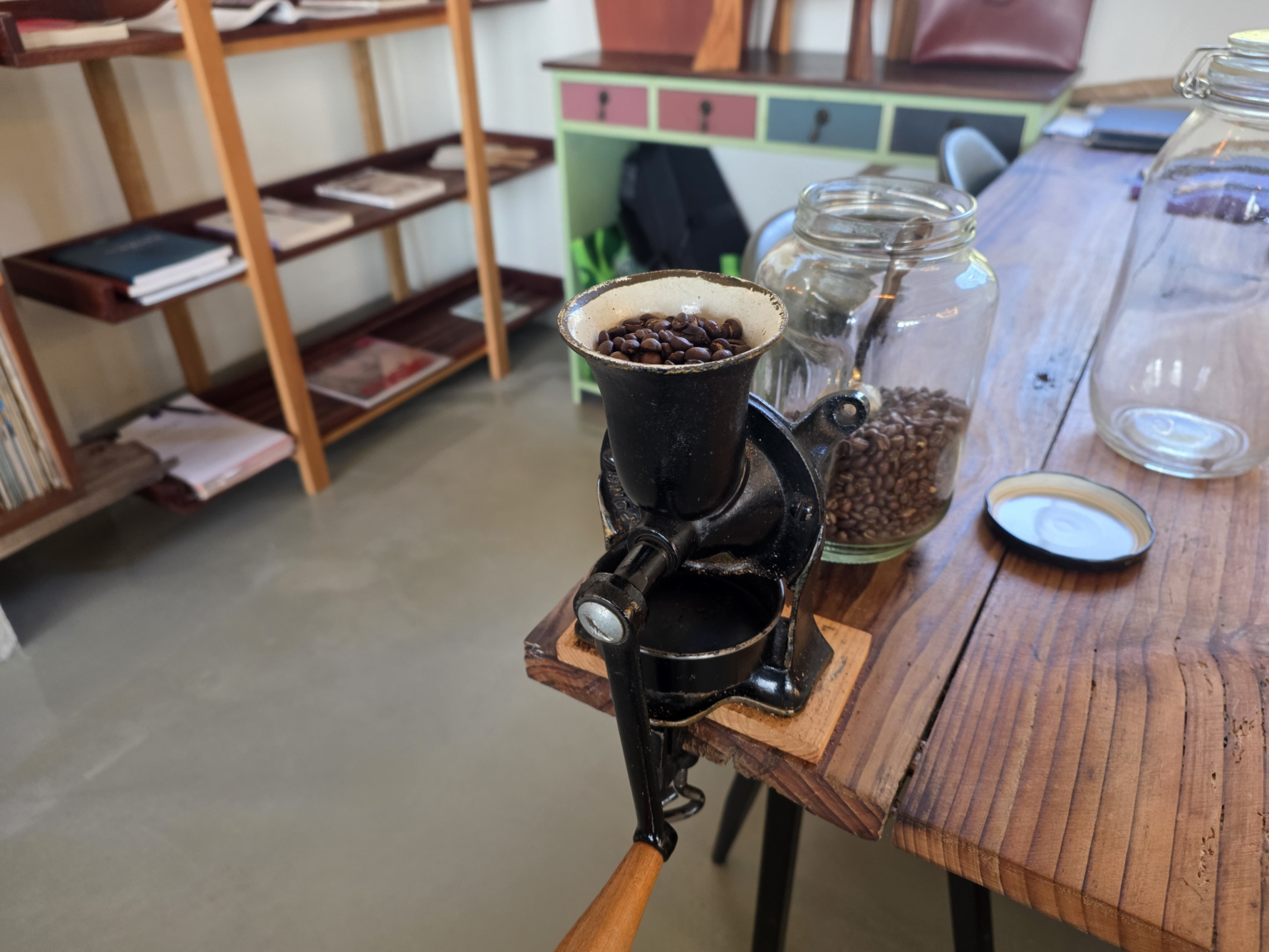 Freshly roasted coffee beans being ground by hand at a cafe on Soakdo